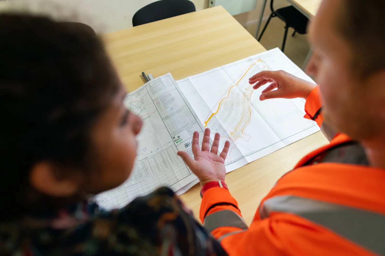 Engineers reviewing technical plans and project maps